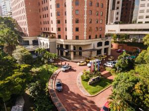 a building with a miniature train in a city at Hotel Dann Carlton Medellín in Medellín