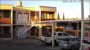 a white truck parked in a parking lot in front of a house at Milena 1, parking amplio y WiFi Starlink in San Juan