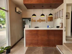 a restaurant with a counter in a room at Motel los Alpes in Ciudad Acuña