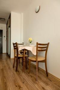 a dining room with a table and chairs at Студио 3 Слънчево Утро in Hisarya +13 photos