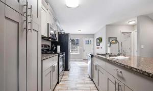 a kitchen with white cabinets and granite counter tops at 43 Making Memories in Leesburg