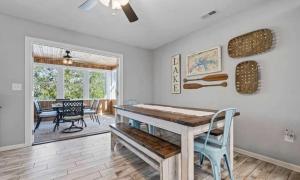 a dining room with a wooden table and a dining room with a ceiling fan at 43 Making Memories in Leesburg