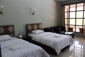 Voodi või voodid majutusasutuse Anoi Itam Resort toas