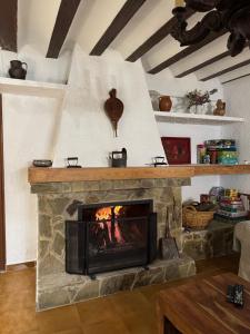 a fireplace in a living room with a fire place at La Casa de Dori in Beteta