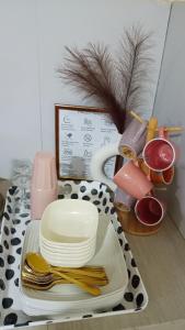 a table with plates and utensils on a table at Villa Amanda and Private Pool in Sampong