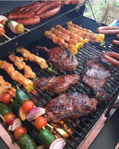 a grill with different types of food on it at Villa Amanda and Private Pool in Sampong