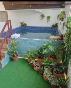 a swimming pool with potted plants in a house at Villa Amanda and Private Pool in Sampong