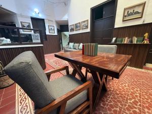 a living room with a wooden table and chairs at Hotel Zamora Downtown CDMX in Mexico City