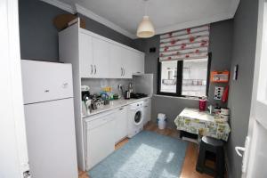 a kitchen with a refrigerator and a washing machine at Amasra Kerem Apart in Amasra
