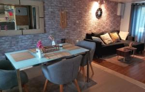 a living room with a table and a couch at La détente in Féchain