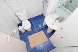 a bathroom with a toilet and a sink at E&M Villa Sea View II in Polychrono
