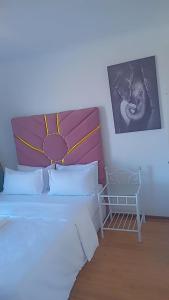 a bedroom with two beds and a picture on the wall at white house Bluewaterbay in Gqeberha