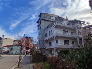 a tall white building on a city street at Amasra Kerem Apart in Amasra