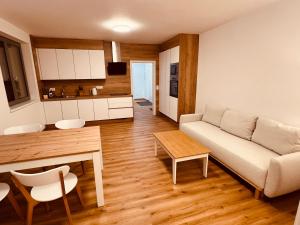 a living room with a couch and a table at PORTA Apartment in Františkovy Lázně