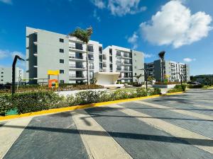 an empty street in front of a large building at Residencia tropical jardines 3 in Punta Cana
