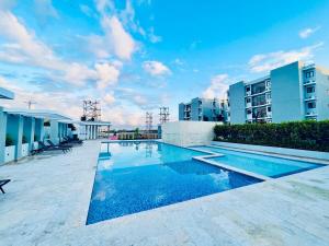 a swimming pool in the middle of a building at Residencia tropical jardines 3 in Punta Cana