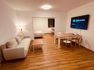 a living room with a couch and a table at PORTA Apartment in Františkovy Lázně