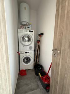 a laundry room with a washer and a washing machine at Serenità - Seaview Penthouse in Marsaskala