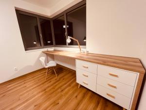 a kitchen with a desk and two windows at PORTA Apartment in Františkovy Lázně +24 photos