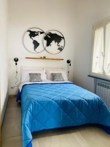 a bedroom with a blue bed with two hearts on the wall at Villa Fiore in Vico Equense