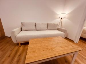 a living room with a couch and a coffee table at PORTA Apartment in Františkovy Lázně