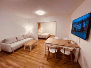 a living room with a couch and a table at PORTA Apartment in Františkovy Lázně