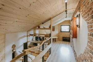 a staircase in a cabin with a brick wall at Cisza Traw in Rabka-Zdroj