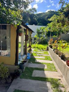 a garden with plants and a house at Reserva da Reserva Praia do Forte in Mata de Sao Joao