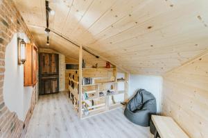 a small room with a couch and a wooden ceiling at Cisza Traw in Rabka-Zdroj