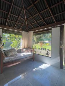 a living room with a couch in front of a window at Reserva da Reserva Praia do Forte in Mata de Sao Joao