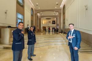 two men and a woman standing in a building at Hotel Dann Carlton Medellín in Medellín