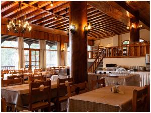 a dining room with tables and chairs and windows at Milionis Forest Hotel in Grevena +42 photos