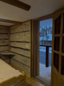 a bedroom with a sliding glass door to a balcony at Pryhirska Sadyba in Torunʼ