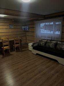 a bedroom with a bed and a table and chairs at Pryhirska Sadyba in Torunʼ