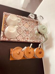 a tray with wooden plates and cups on a table at Luna Holiday Home in Maun