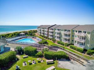 an aerial view of a resort with a pool and the ocean at Pebble Beach I305 by Emerald Isle Realty in Emerald Isle +45 photos
