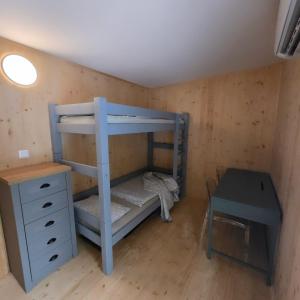 a small room with a bunk bed and a desk at Hillside Cabin in Pomezí +58 photos