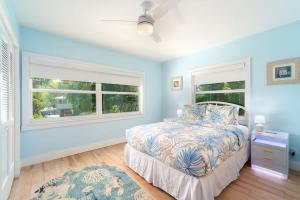 a bedroom with a bed and two windows at Reel Caribbean Getaway in Summerland Key +57 photos