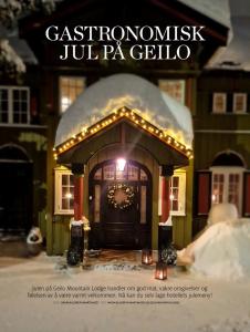 a christmas house with a christmas wreath on the door at Geilo Mountain Lodge in Geilo