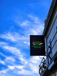 a sign on the side of a building with a blue sky at Urban Lounge Sleepery Carterton in Carterton