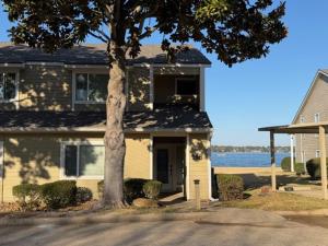 a house with a tree in front of it at Lake Vibes with Champagne Views in Montgomery