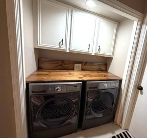 a kitchen with two washer and dryer under cabinets at Lake Vibes with Champagne Views in Montgomery +6 photos