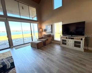 a living room with a large flat screen tv at Lake Vibes with Champagne Views in Montgomery