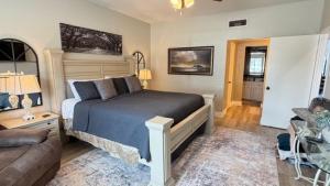 a bedroom with a large bed and a couch at Lake Vibes with Champagne Views in Montgomery