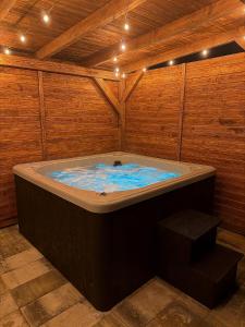 a jacuzzi tub in a wooden room at Górska Stodoła - Domek z Prywatnym Jacuzzi in Lipowa