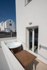a bathroom with a tub and a sink on a roof at Santo Evdokia in Vóthon