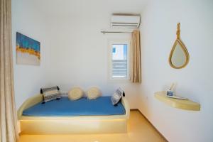 a bedroom with a bed in a room with a window at Santo Evdokia in Vóthon