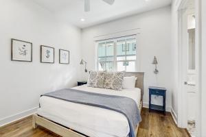 a white bedroom with a bed and a window at The Fairway Farmhouse in Port Aransas +24 photos