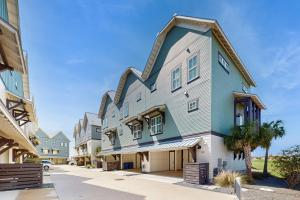a house with a gambrel roof on a street at The Fairway Farmhouse in Port Aransas