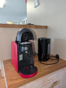 a black and red coffee maker sitting on a counter at La vague in Camiers